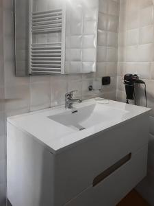 a bathroom with a white sink and a mirror at Vanvitelli Home in Caserta