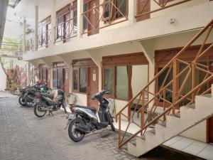 eine Gruppe von Motorrädern, die außerhalb eines Gebäudes geparkt sind in der Unterkunft SUPER OYO 591 Mn Residence Syariah in Jakarta