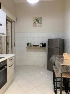 a kitchen with a refrigerator and a table in it at Casa Leila in Palermo