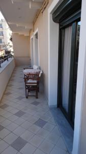 a patio with a table and chairs on a balcony at ΜΑΝΑΒΙΚΑ in Tríkala