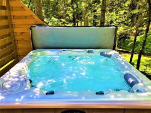 a jacuzzi tub sitting in a backyard at Exclusive 2 Chalet Stay-HotTub-Fireplace-Beachside in Traverse City