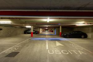 un garage con due auto parcheggiate in esso di Ramada Plaza Milano a Milano