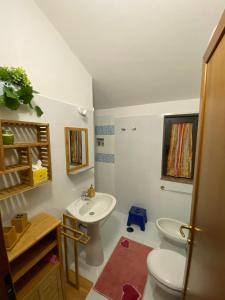 a bathroom with a white sink and a toilet at Alloggio Turistico La Balocca in Montefiascone +71 photos