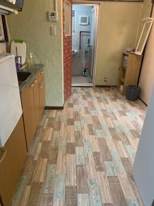 a kitchen with a tile floor in a room at 山下ホテル308 in Kurosakimachi