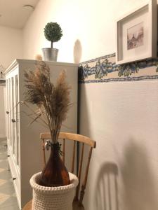 a vase sitting on a chair in a room at Haus Anna in Rauma