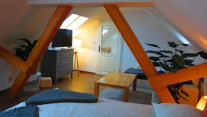 a bedroom with a staircase with a bed and a television at Ferienhaus Gute Laune in Lichtenhagen