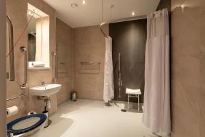 a bathroom with a shower and a toilet and a sink at The Saxon Crown Wetherspoon in Corby