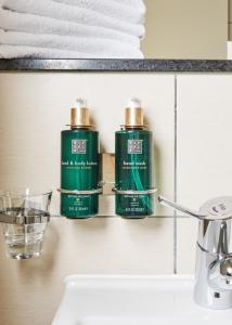 two green bottles on a shelf above a sink at Temple Bar Inn in Dublin +60 photos