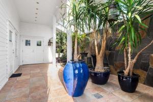 a hallway with three large blue vases with trees in them at Lovely apartment in maritime surroundings near Stavanger in Stavanger