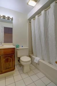 a bathroom with a toilet and a tub and a sink at Classic Inn in Saco