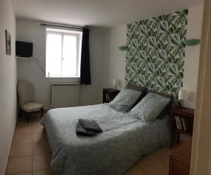 a bedroom with a bed with a large green wall at GITE DE LA FONTAINE 