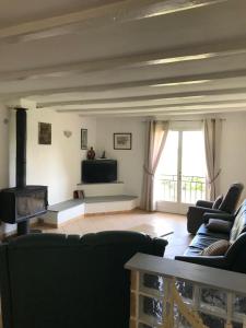 a living room with a couch and a fireplace at GITE DE LA FONTAINE 