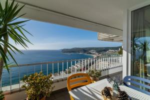 a balcony with a view of the ocean at To see the sea apartment in Sesimbra