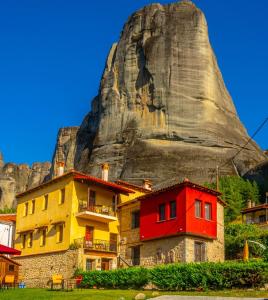 a group of houses in front of a mountain at Archontiko Mesohori Meteora in Kalabaka