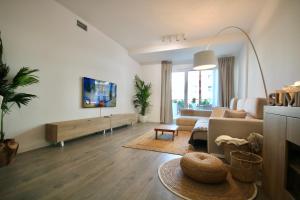 a living room with a couch and a table at Aguacate Beach Apartamentos Playa Granada in Motril