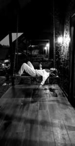 a man laying on a swing at night at El Granero De Frida in Boquete