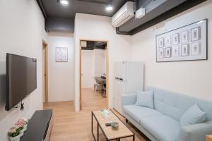 HotelsHere - Ximen في تايبيه: غرفة معيشة مع أريكة وتلفزيون