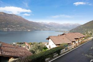 a view of a town with a lake and mountains at Ampia vista sul lago di Como in Bellano