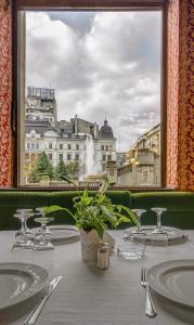 a table with a view of a city from a window at Capitol Hotel in Bucharest