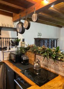 a kitchen with a stove and pots and pans at Casa rural Castro de Frádigas, con vistas al mar en Pantín in Valdoviño