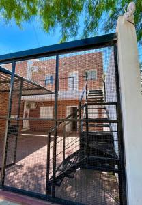 a cage with stairs in front of a building at Departamentos "La Perla" in Andalgalá