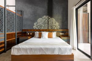 a bedroom with a large white bed in a room at Lumina at Mudra Tulum in Tulum