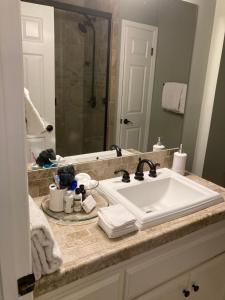 a bathroom with a white sink and a mirror at Spacious 3 Bedroom 2 bath Condo close to Five-points in Athens in Athens