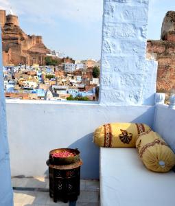 a view of a city from a window with pillows at Jewel Palace Haweli in Jodhpur