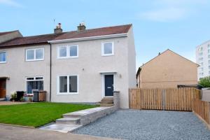 a house with a wooden fence and a yard at Vion Apartment- Westerton in Aberdeen