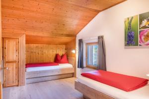 a bedroom with two beds in a wooden cabin at Apartment Völs Gfliererhof in Vols am Schlern