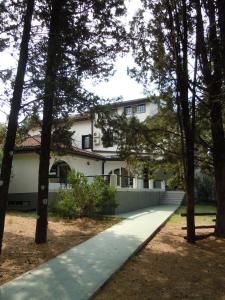 a white house with trees in front of it at Hotel Park in Višići