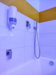 a bathroom with a shower with a shower head at La Petite APARTMENTS in Gdańsk