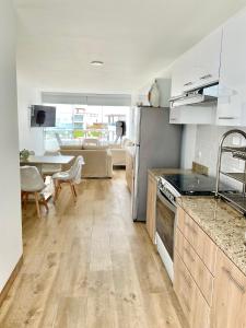 a kitchen with a refrigerator and a table in a room at Solymar Beach House - Paracas in Paracas