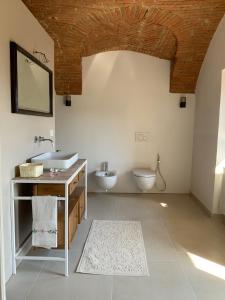 uma casa de banho com um lavatório e um WC em Appartamento Biò em Borgofranco dʼIvrea