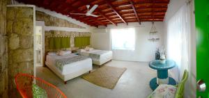 a bedroom with two beds and a window at Casa Camara in Sian ka'an in Punta Allen