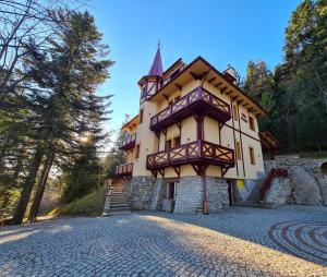 a house on a hill with a cobblestone street at Villa Rusalka in Tatranská Kotlina