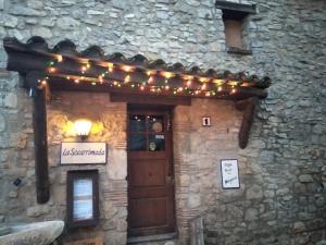 a stone building with a door and lights on it at Cal Tous, La Socarrimada in Rojals