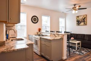 a kitchen and living room with a stove and a couch at Beautiful Pittsburgh home-walkable area w parking in Pittsburgh