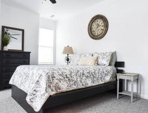 a bedroom with a bed and a clock on the wall at Beautiful Pittsburgh home-walkable area w parking in Pittsburgh