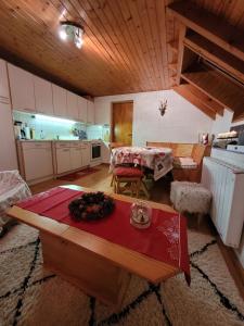 a living room with a table and a kitchen at Appartement chaleureux au cœur des Hautes Vosges in Ventron