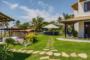 um jardim com um caminho em frente a uma casa em Pousada Aldeola by Slaviero Hotéis em Baixio