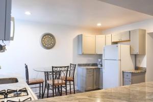 a kitchen with a white refrigerator and a table at Perfect Mount Washington Home Walkable w Parking in Pittsburgh