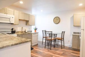a kitchen with white cabinets and a table and chairs at Perfect Mount Washington Home Walkable w Parking in Pittsburgh +12 photos