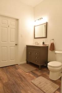 a bathroom with a toilet and a sink and a mirror at Relax & Feel At Home During Your Pittsburgh Stay in Pittsburgh