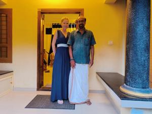 a man and a woman standing in front of a mirror at Swasthi Griha in Aranmūla