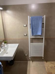 a bathroom with a sink and a blue towel on a towel rack at Casale Riorso in Orvieto