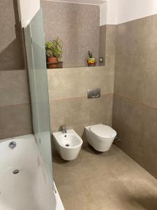 a bathroom with a toilet and a bidet and a sink at Casale Riorso in Orvieto