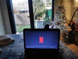 a laptop computer with the letter n on the screen at İstanbul Airport Bungalow With Terrace in Arnavutköy