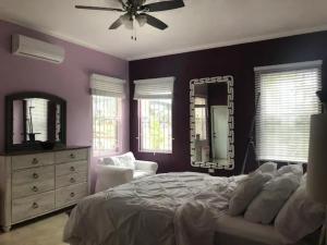 a bedroom with a bed and a dresser and a mirror at Bella Vista Vacation in Montego Bay