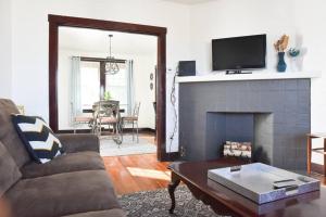 a living room with a couch and a fireplace at Beautiful 3 Bedroom Home Cozy Front and Back Porch in Munhall